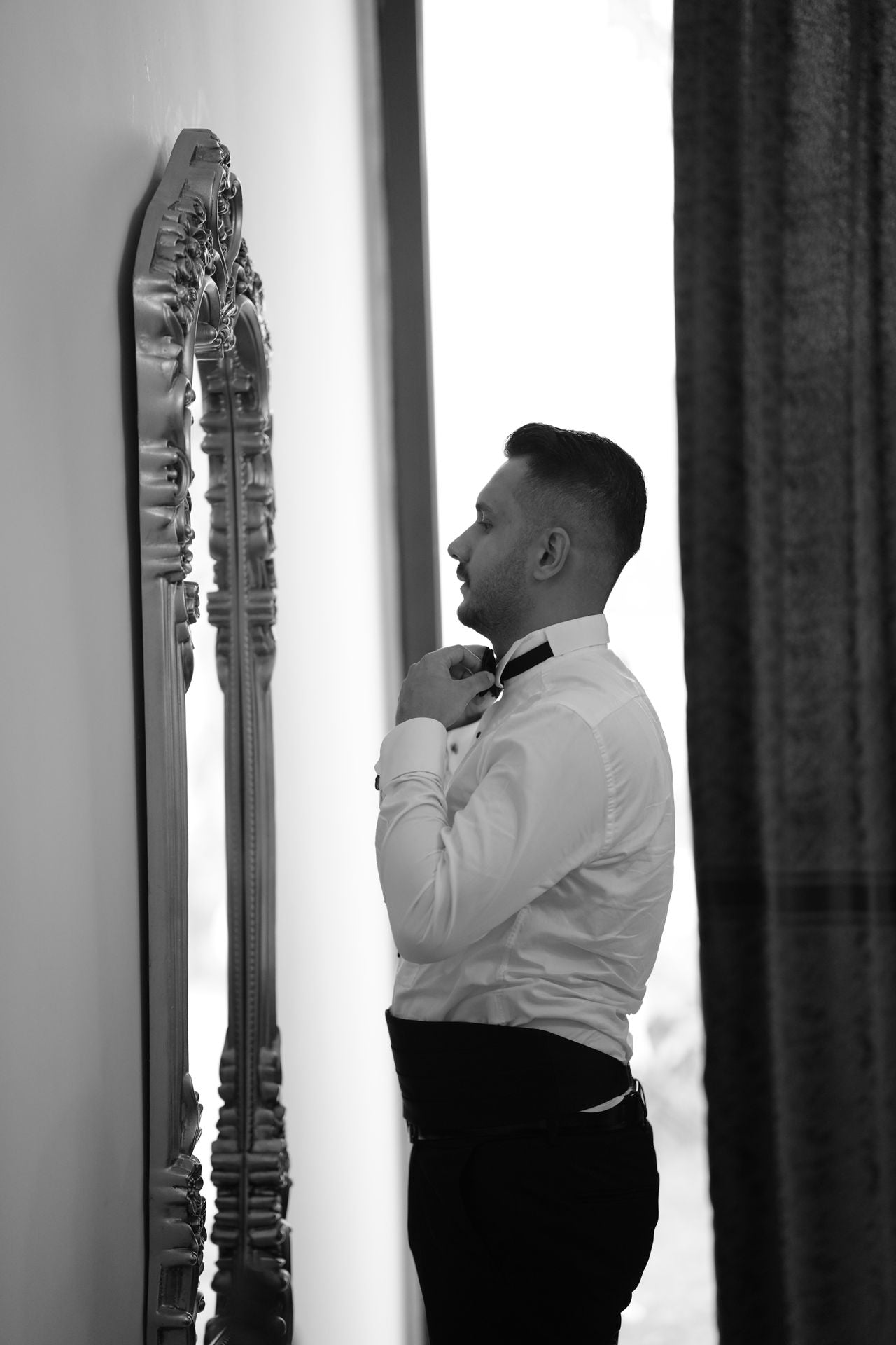 Professional groom dressing and wedding morning support at a luxury London hotel, preparing a tailored tuxedo, bow tie and formalwear.