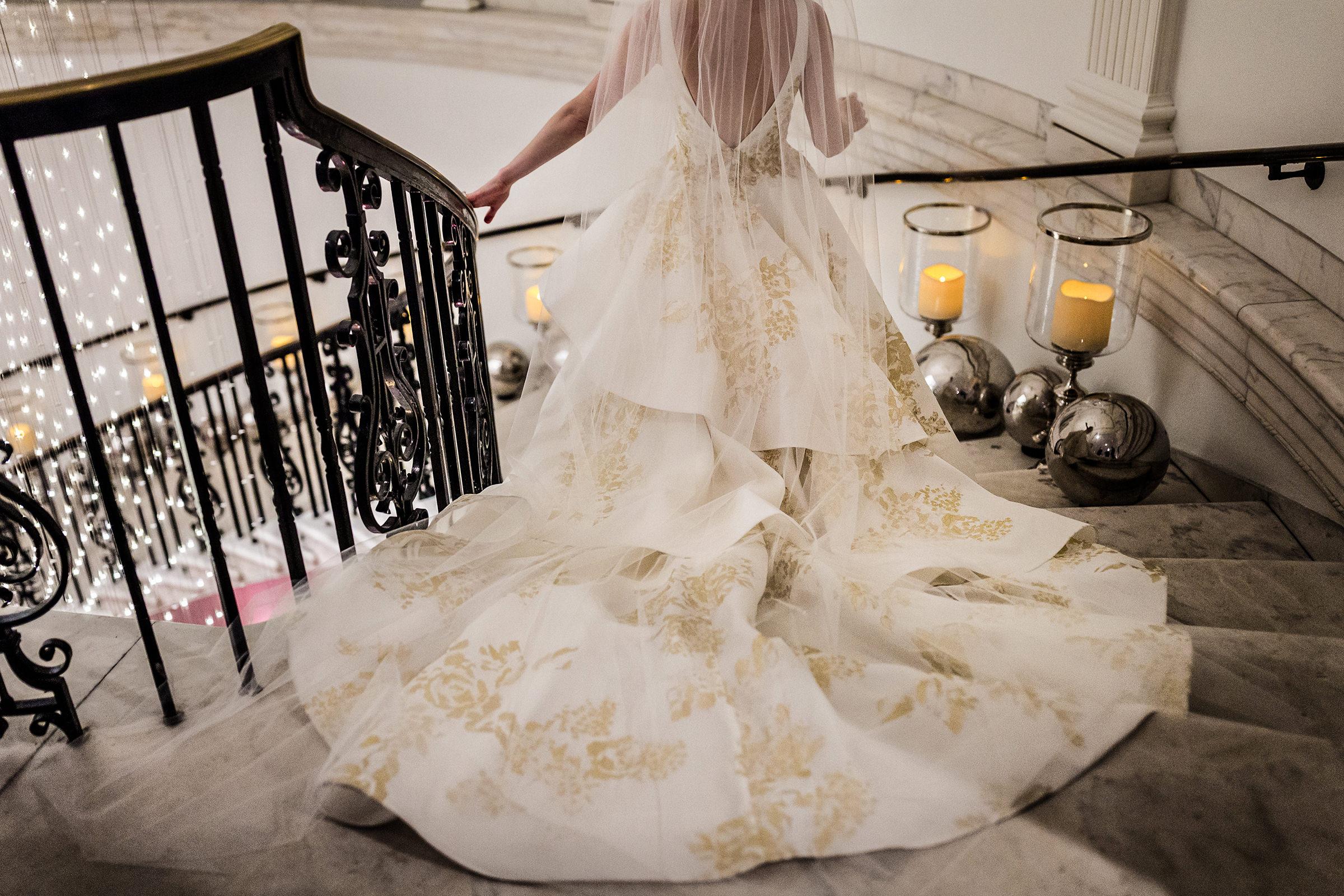 Bride preparing to be dressed in a hotel suite