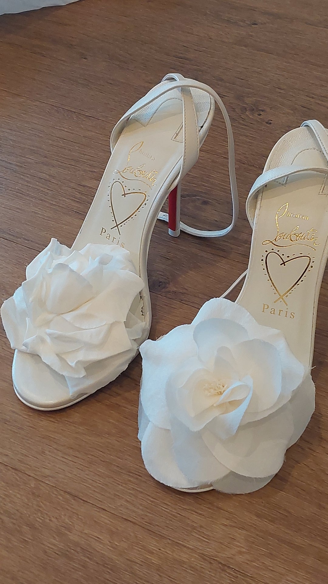 Steaming the flower motif on Christian Louboutin heels as part of the bride's wedding look at Hylands House in Chelmsford. The right foot not steamed, the left foot steamed
