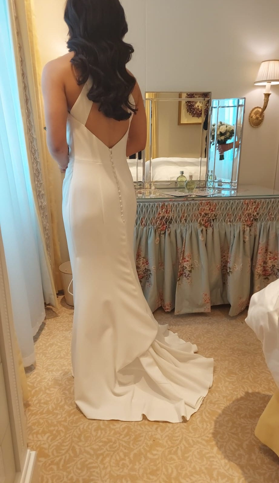 bride wearing a wedding dress in a french bustle